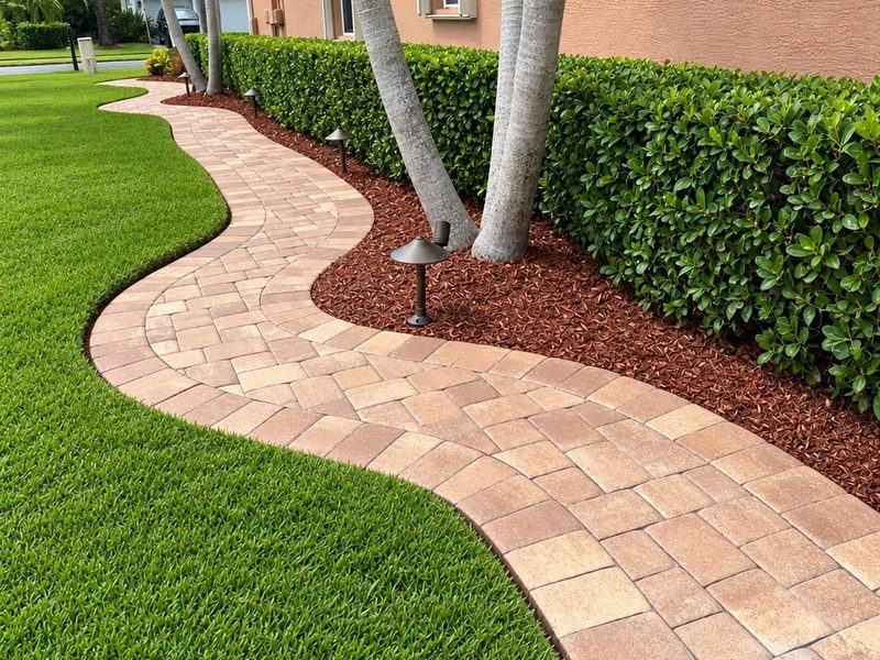 The same walkway after โ pavers cleared, hedge shaped and beds re-mulched